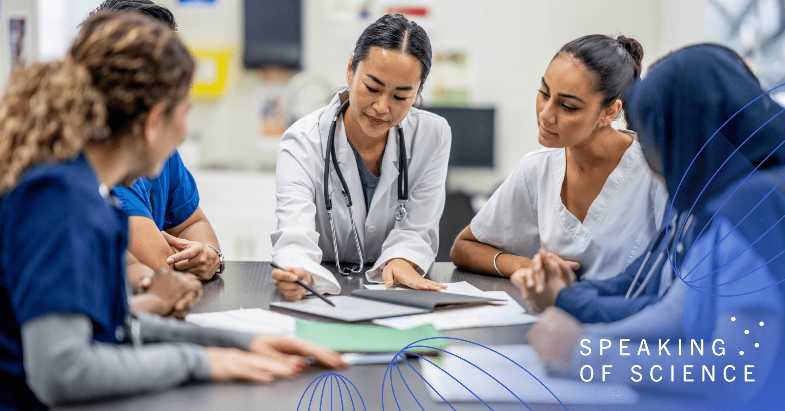 Group of medical professionals discussing paperwork