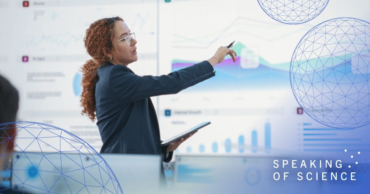 Woman pointing to information on a screen as she presents